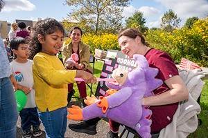 Dental hygiene students show children how to brush their teeth 